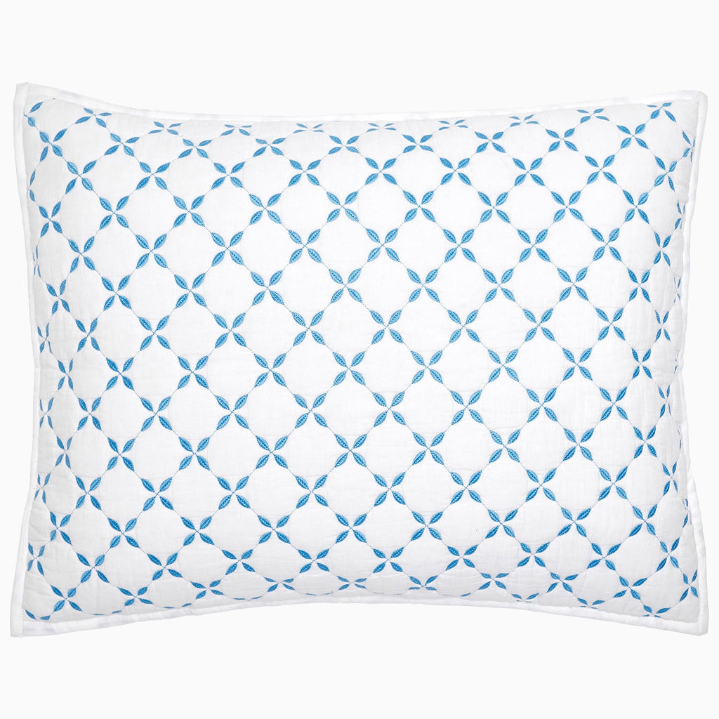 A Layla Azure Quilt pillow by John Robshaw with a blue and white geometric pattern.