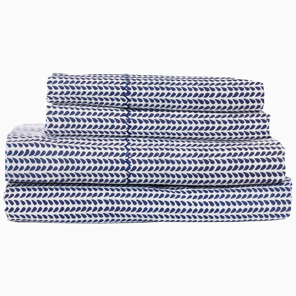 "A stack of 200 Cinde Indigo Organic Sheet Set by John Robshaw, indigo and white patterned sheets."