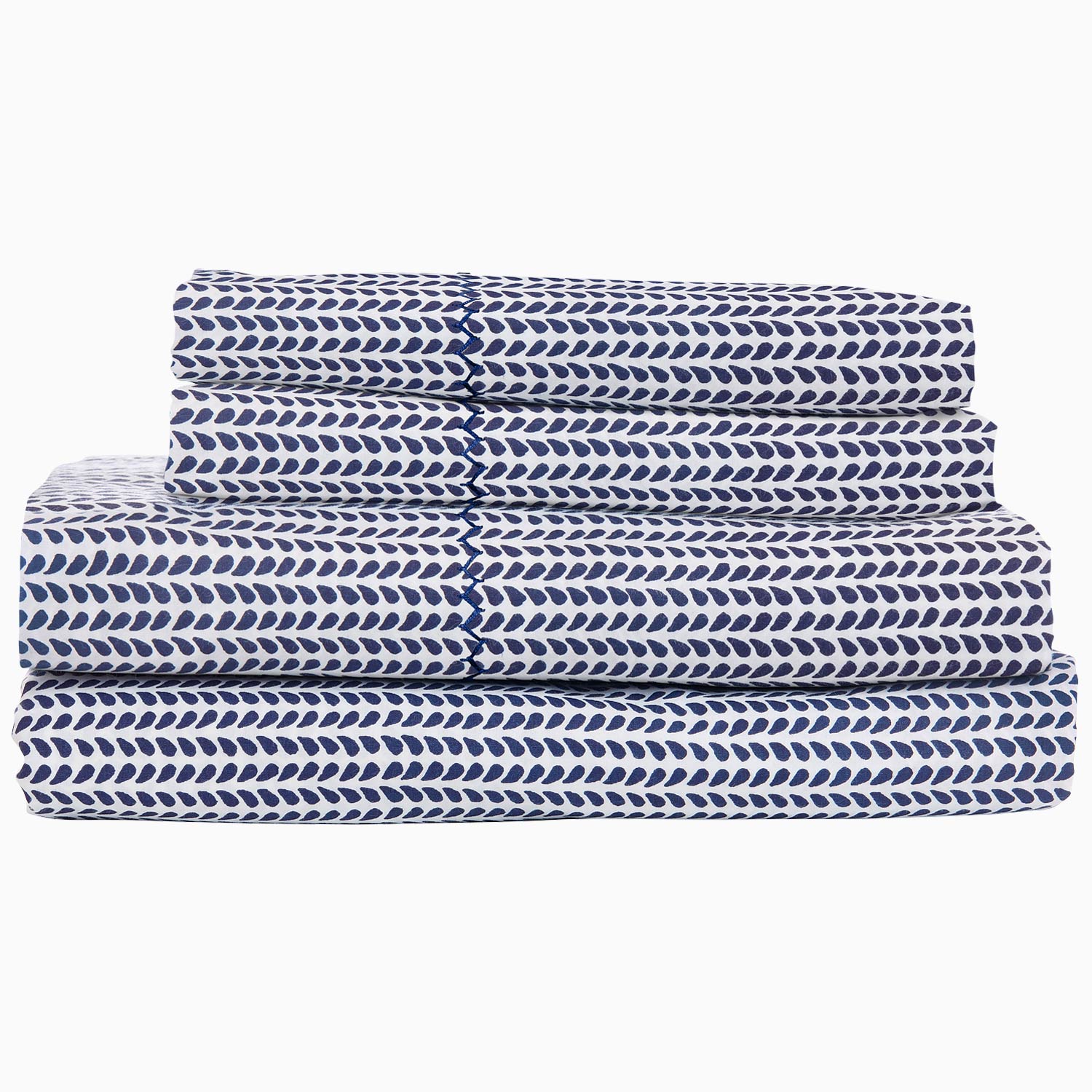 "A stack of 200 Cinde Indigo Organic Sheet Set by John Robshaw, indigo and white patterned sheets."