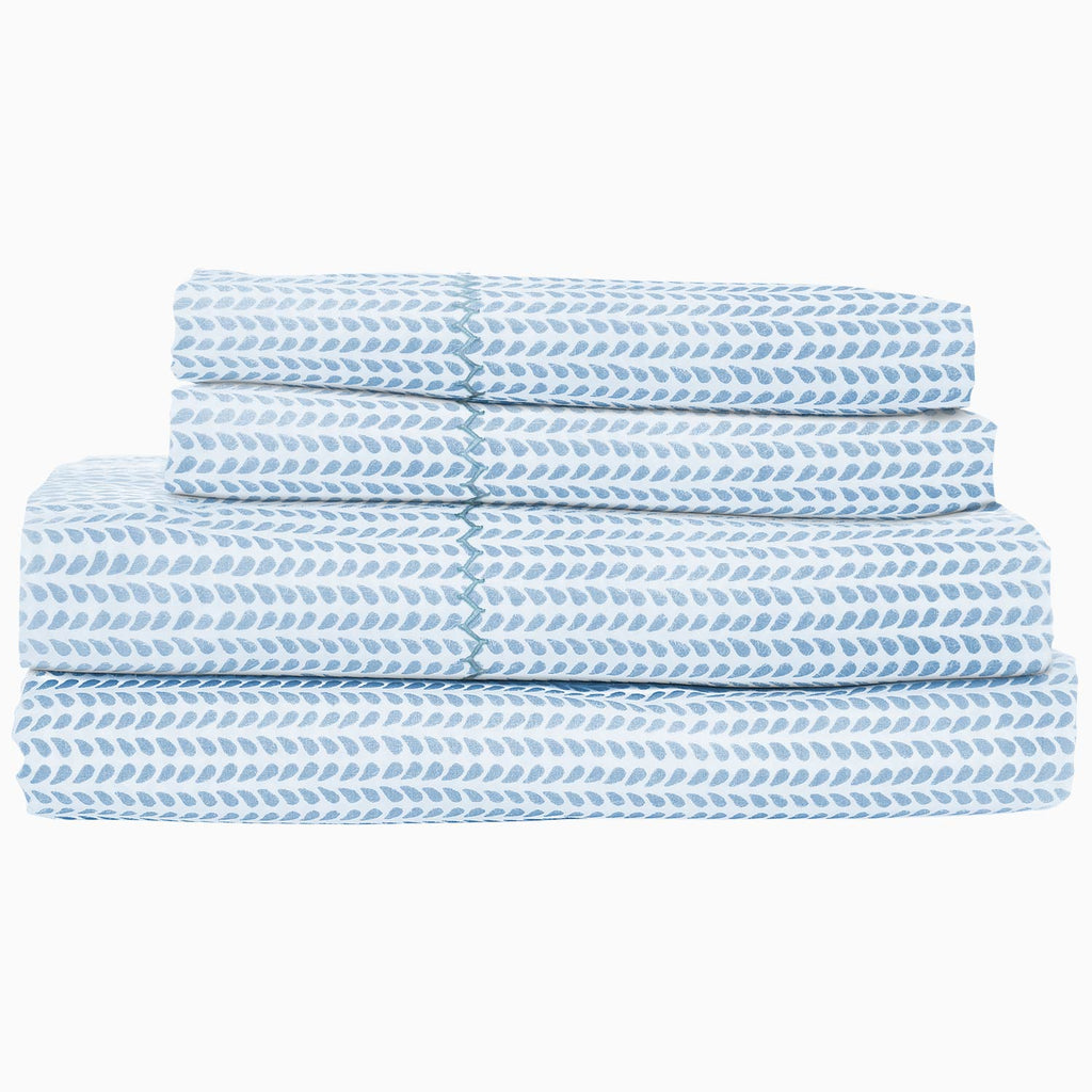 John Robshaw's Cinde Light Indigo Organic Sheet Set is a blue and white chevron sheet set made of 100% cotton percale.