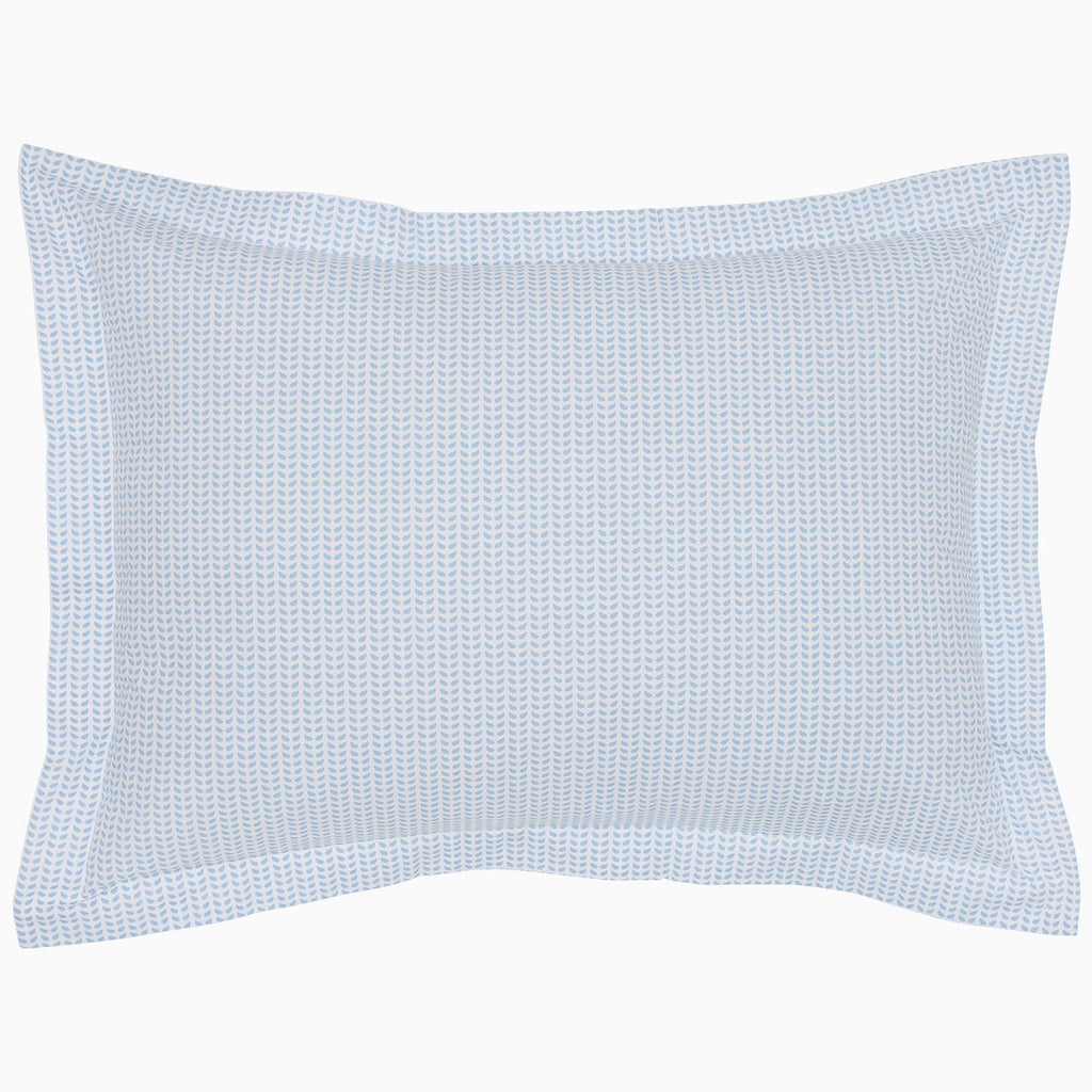 "The Cinde Light Indigo Organic Duvet by John Robshaw is a rectangular pillow with a light blue and white patterned cover, featuring a 200 thread count percale with small repeated designs and a flanged edge."